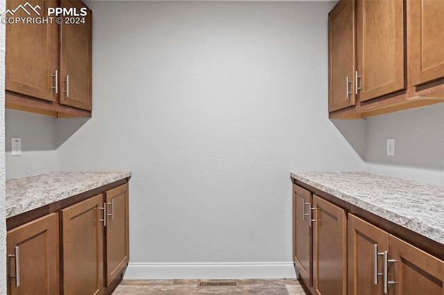 laundry area featuring light hardwood / wood-style flooring