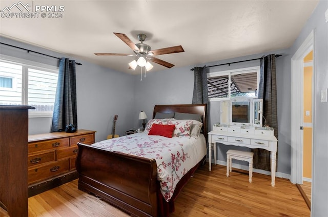 bedroom with light wood-type flooring and ceiling fan