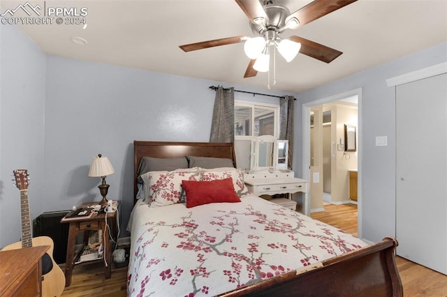 bedroom featuring ceiling fan, light hardwood / wood-style flooring, and ensuite bath