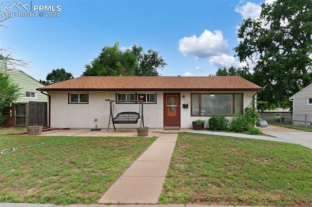 ranch-style house with a front lawn