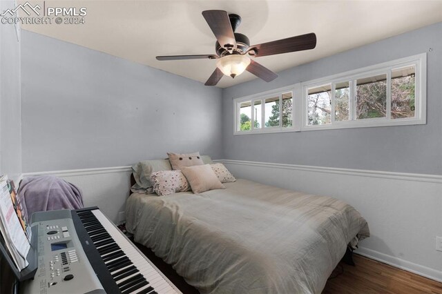 bedroom with ceiling fan and wood-type flooring