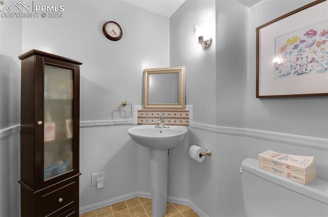 bathroom featuring toilet and tile patterned floors