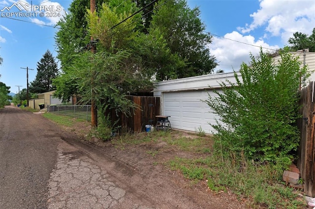 exterior space with an outdoor structure and a garage