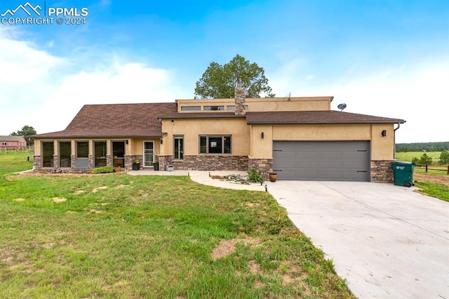 view of front of house featuring a garage and a front lawn