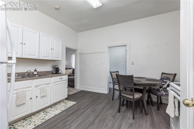 kitchen featuring sink, dark hardwood / wood-style flooring, and white cabinetry