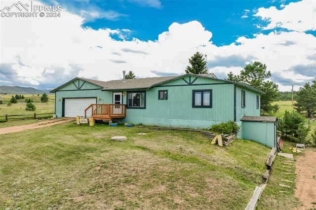 view of front of house with a wooden deck, a front lawn, and a rural view