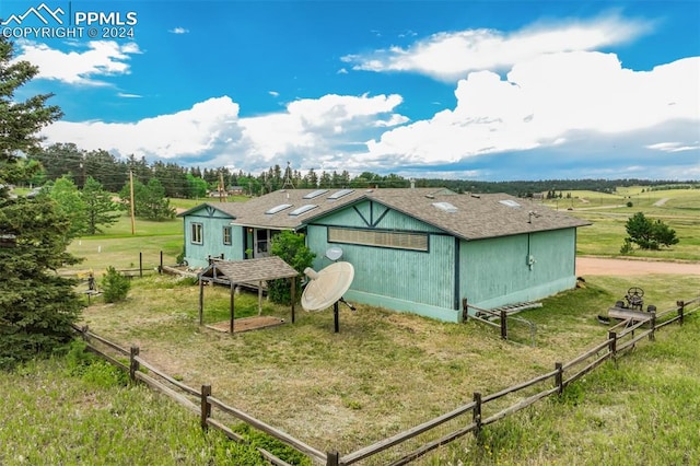 exterior space with a rural view and a yard