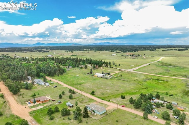 birds eye view of property featuring a mountain view and a rural view