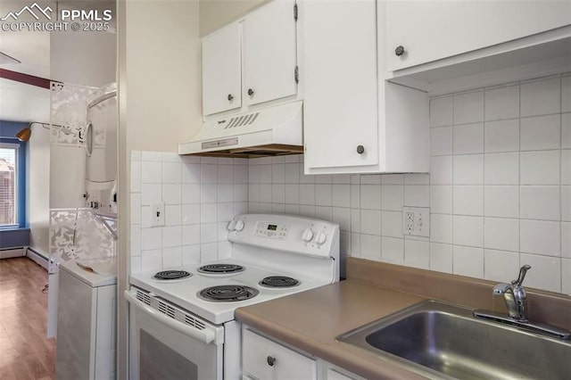 kitchen featuring electric stove, custom exhaust hood, stacked washer / drying machine, white cabinetry, and a sink