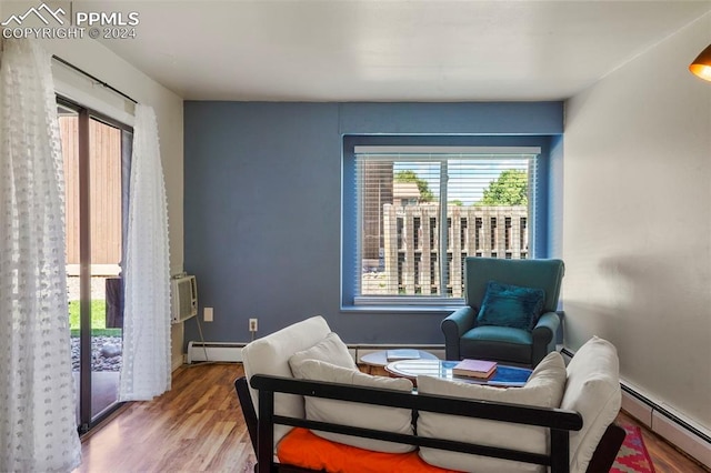 sitting room with a baseboard radiator and wood-type flooring