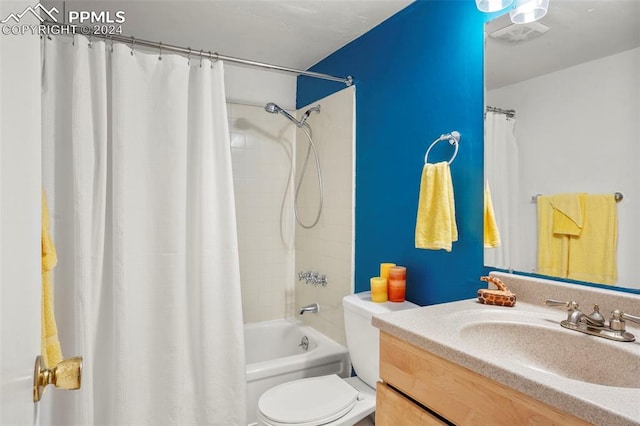 bathroom with toilet, shower / bath combination with curtain, and vanity