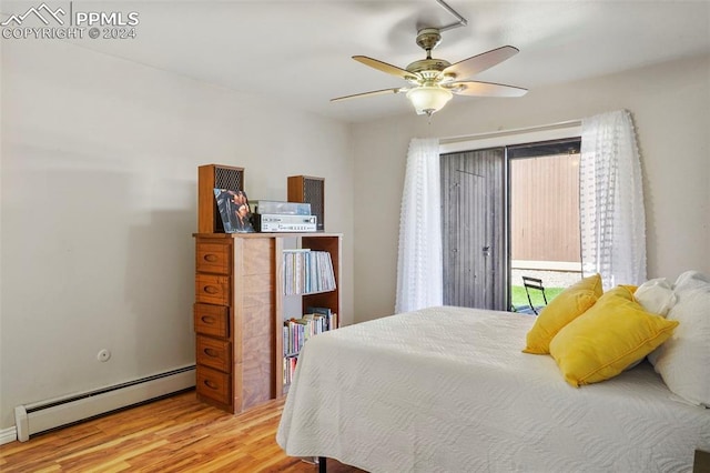 bedroom with baseboard heating, light wood-type flooring, and ceiling fan