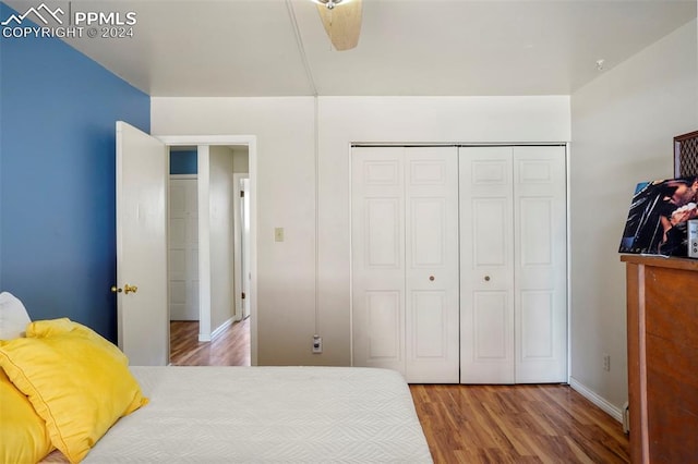 bedroom with ceiling fan, hardwood / wood-style flooring, and a closet