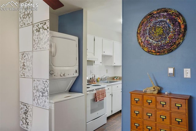 kitchen with white electric stove, light countertops, white cabinetry, a sink, and stacked washing maching and dryer