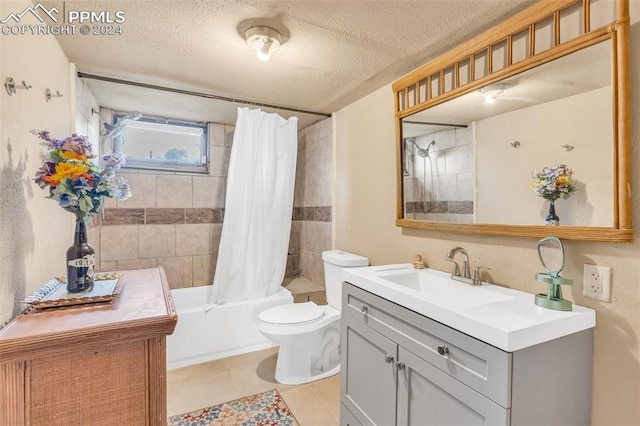 full bathroom featuring tile patterned flooring, vanity, a textured ceiling, toilet, and shower / bath combo with shower curtain