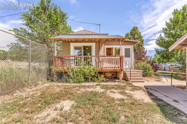 back of property featuring a wooden deck