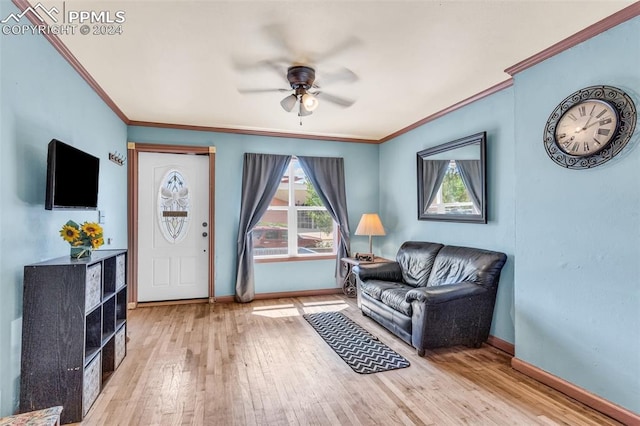 living room with crown molding, ceiling fan, and light wood-type flooring