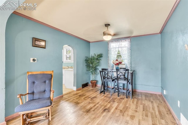 sitting room featuring crown molding, ceiling fan, and light wood-type flooring