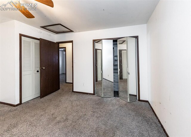 unfurnished bedroom featuring ceiling fan and carpet floors