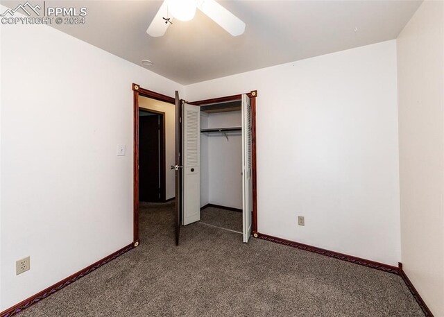 unfurnished bedroom with ceiling fan, carpet flooring, and a closet