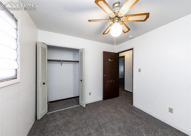 unfurnished bedroom with ceiling fan, carpet floors, and a closet