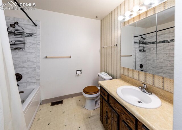 full bathroom with tiled shower / bath combo, vanity, tile patterned flooring, and toilet