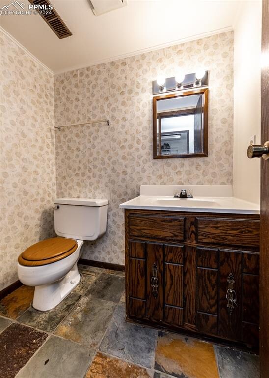 bathroom with toilet, tile patterned floors, and vanity