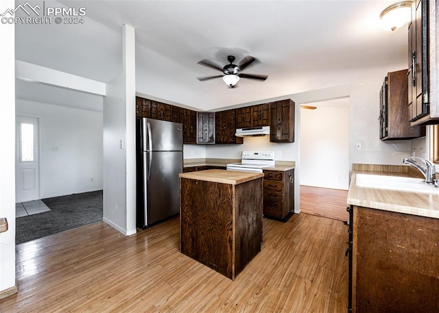 kitchen featuring stainless steel refrigerator, white electric range, dark brown cabinetry, wood counters, and light wood-type flooring