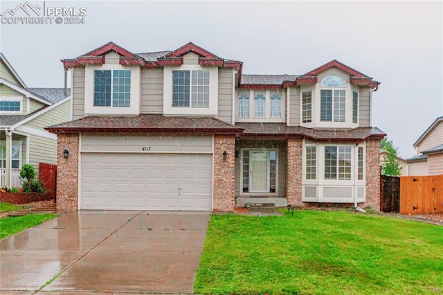 view of front of house with a garage and a front yard