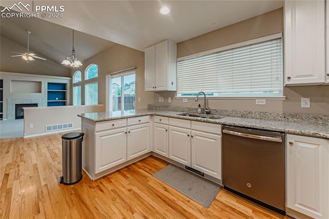 kitchen with lofted ceiling, dishwasher, white cabinetry, and sink