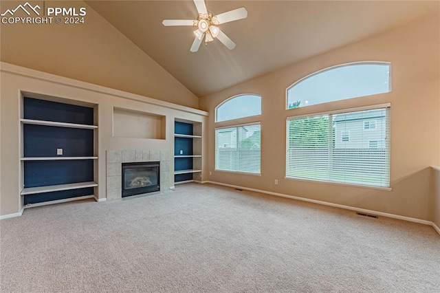 unfurnished living room featuring a fireplace, carpet flooring, ceiling fan, built in features, and high vaulted ceiling