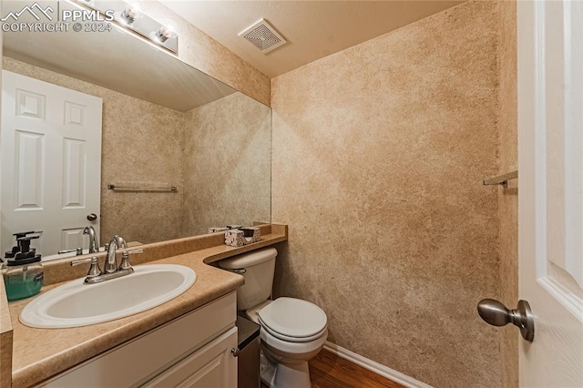 bathroom featuring hardwood / wood-style floors, toilet, and vanity