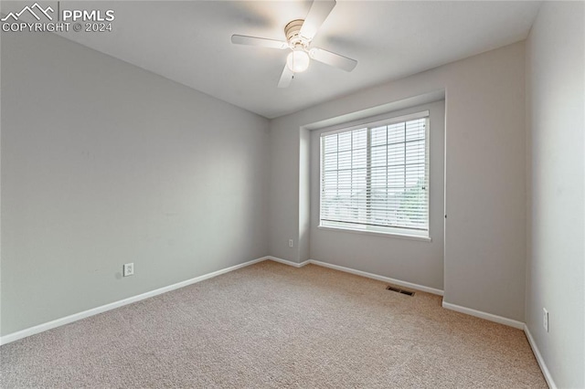 carpeted empty room with ceiling fan