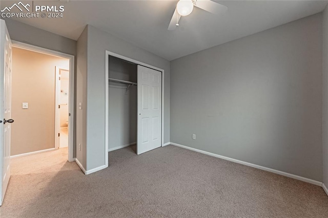 unfurnished bedroom with a closet, ceiling fan, and carpet