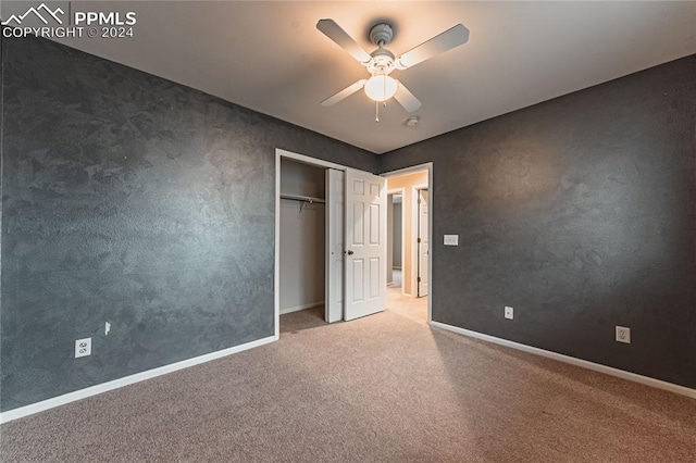 unfurnished bedroom with a closet, ceiling fan, and carpet