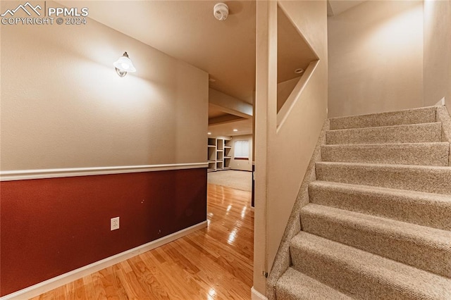 stairway featuring wood-type flooring