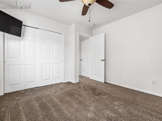 unfurnished bedroom featuring ceiling fan, a closet, and carpet