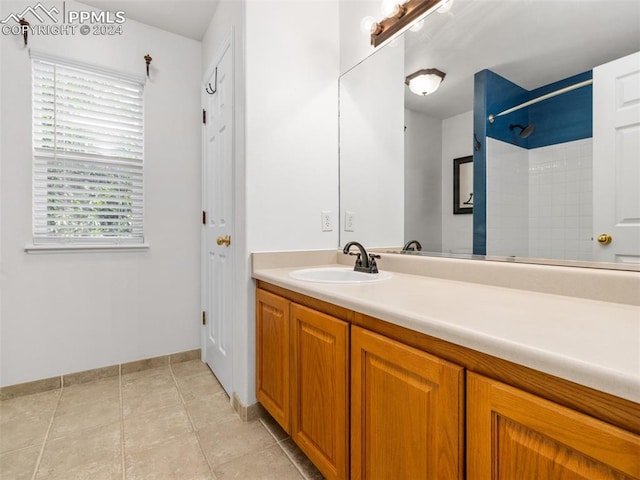 bathroom with tile patterned floors and vanity