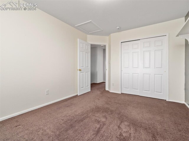 unfurnished bedroom with carpet flooring and a closet