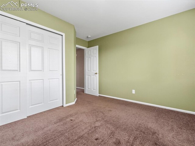 unfurnished bedroom with carpet floors and a closet