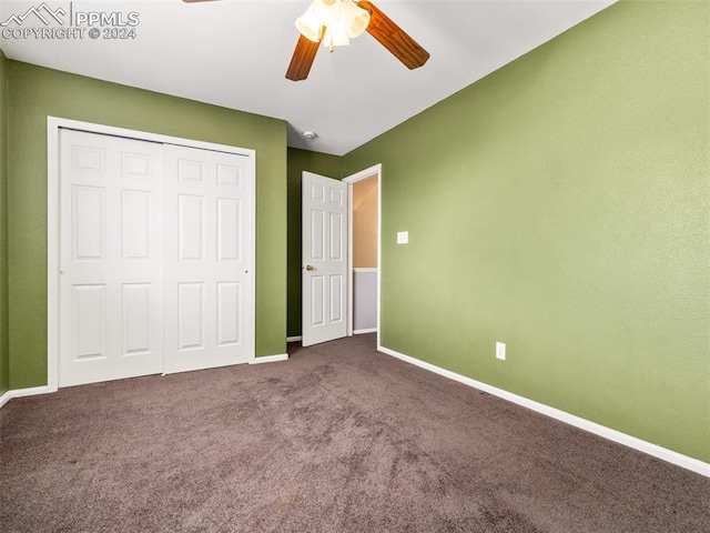 unfurnished bedroom featuring ceiling fan, a closet, and carpet