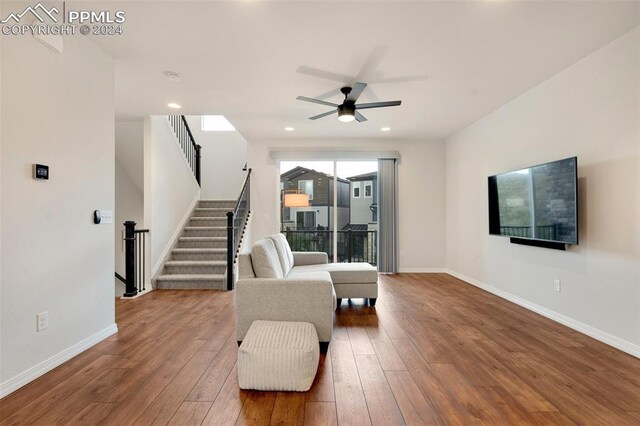 sitting room featuring ceiling fan and wood-type flooring