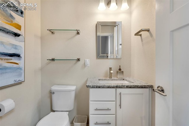 bathroom with toilet and vanity