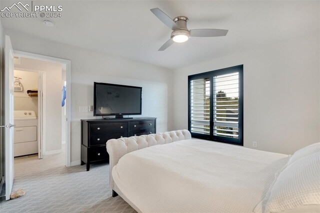 bedroom with ceiling fan, washer / dryer, and light carpet