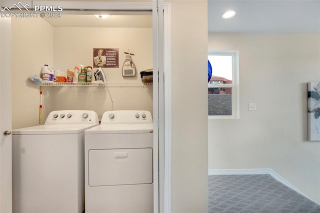 laundry area with washer and clothes dryer and carpet flooring