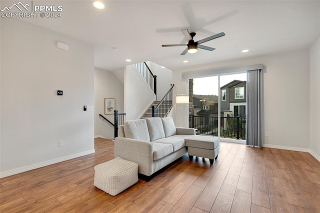 living room with ceiling fan and wood-type flooring