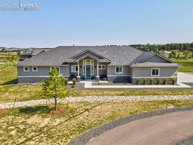 single story home featuring a front lawn