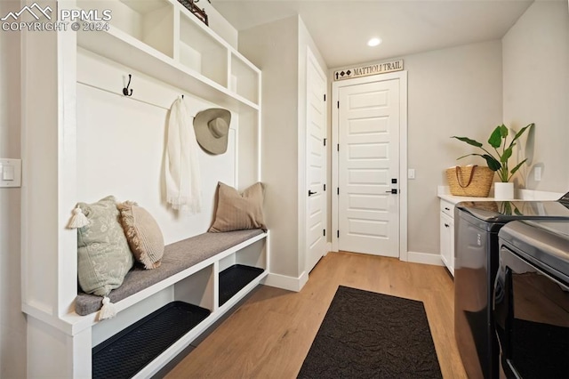 mudroom featuring washer and clothes dryer and light hardwood / wood-style floors