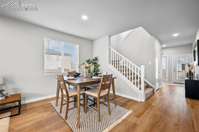 dining space with light hardwood / wood-style floors and plenty of natural light