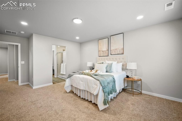 bedroom with carpet floors and connected bathroom